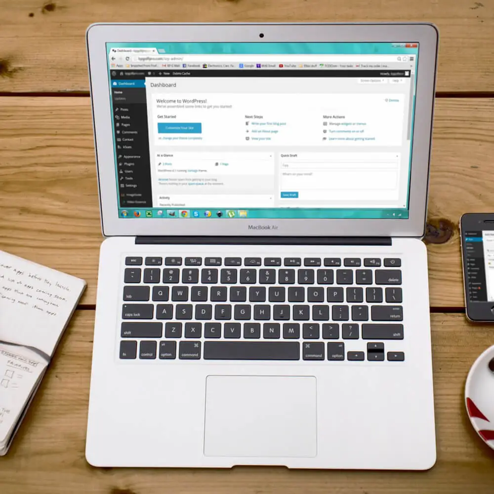 Developer working at a laptop comparing website options